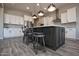 Kitchen with large center island, stainless steel appliances, white cabinets and bar stool seating at 20210 N Wagner Wash Dr, Buckeye, AZ 85396