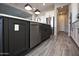 Kitchen with gray island, white cabinets, stainless steel appliances and wood-look tile flooring at 20210 N Wagner Wash Dr, Buckeye, AZ 85396