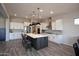 Spacious kitchen with a large island, pendant lighting, and stainless steel appliances at 20210 N Wagner Wash Dr, Buckeye, AZ 85396