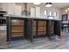 Spacious kitchen island offers ample storage with pull-out shelves and sleek gray cabinets at 20210 N Wagner Wash Dr, Buckeye, AZ 85396