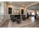 Cozy sitting area with two modern chairs, a rug, and views into the dining room at 20210 N Wagner Wash Dr, Buckeye, AZ 85396