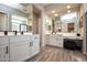 Beautiful main bathroom with dual vanities, sleek fixtures, and large mirrors at 20210 N Wagner Wash Dr, Buckeye, AZ 85396