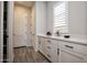 Bright mudroom featuring white cabinetry, countertop space, and easy access to nearby rooms at 20210 N Wagner Wash Dr, Buckeye, AZ 85396