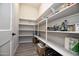 Organized walk-in pantry with extensive shelving for optimal storage and convenience at 20210 N Wagner Wash Dr, Buckeye, AZ 85396