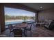 A covered patio overlooks the sparkling pool providing shade and a comfortable outdoor living space at 20210 N Wagner Wash Dr, Buckeye, AZ 85396