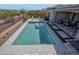 This backyard features a sparkling pool with a seating area, perfect for relaxation and entertaining guests at 20210 N Wagner Wash Dr, Buckeye, AZ 85396