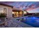 Relaxing backyard with pool, covered patio, and outdoor kitchen for luxury living at 20210 N Wagner Wash Dr, Buckeye, AZ 85396