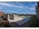Beautiful outdoor space with a pool, outdoor grill area, and mature landscaping at 20210 N Wagner Wash Dr, Buckeye, AZ 85396