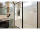 Close up of shower with built in bench and glass door at 20210 N Wagner Wash Dr, Buckeye, AZ 85396