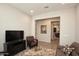 Comfortable sitting area with a plush sofa, patterned rug, and neutral paint at 20210 N Wagner Wash Dr, Buckeye, AZ 85396