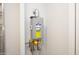 The tankless water heater is an efficient Rheem model with digital controls and yellow energy guide label at 20210 N Wagner Wash Dr, Buckeye, AZ 85396