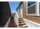 Side view of home featuring a staircase leading to a door and a small yard space at 2060 N Center St # 138, Mesa, AZ 85201
