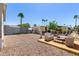 Wide gravel backyard with a small patio, illustrating a manageable outdoor area with relaxing seating at 2060 N Center St # 138, Mesa, AZ 85201