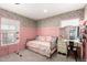 Stylish bedroom featuring floral wallpaper, pink wainscoting, and a vanity with a mirror at 2060 N Center St # 138, Mesa, AZ 85201
