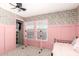 Stylish bedroom featuring floral wallpaper, pink wainscoting, and access to the walk-in closet at 2060 N Center St # 138, Mesa, AZ 85201