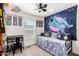 Fun bedroom decorated with a space theme, a desk, and a comfortable bed at 2060 N Center St # 138, Mesa, AZ 85201