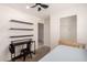 Bright bedroom with a desk, shelving, and closet space, offering a functional and comfortable area at 2060 N Center St # 138, Mesa, AZ 85201