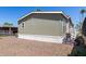 Neutral-colored home with gravel landscaping and a white porch railing, showing a simple yet functional design at 2060 N Center St # 138, Mesa, AZ 85201