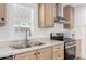 Charming kitchen featuring stainless steel appliances, light wood cabinets, and a double basin sink at 2060 N Center St # 138, Mesa, AZ 85201