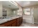 Bathroom with dual sinks, granite counters, tub, separate shower, and bright lighting at 2122 W Alta Vista Rd, Phoenix, AZ 85041