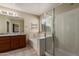Bathroom featuring dual sinks, granite counters, a soaking tub, and a separate glass-enclosed shower at 2122 W Alta Vista Rd, Phoenix, AZ 85041