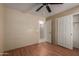 Comfortable bedroom with wood laminate flooring, ceiling fan, and closet with door at 2122 W Alta Vista Rd, Phoenix, AZ 85041