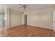 Cozy bedroom showcasing wood laminate flooring, ceiling fan, and convenient access to an ensuite bathroom at 2122 W Alta Vista Rd, Phoenix, AZ 85041