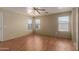 Bright bedroom with wood laminate flooring, ceiling fan, and multiple windows for natural light at 2122 W Alta Vista Rd, Phoenix, AZ 85041