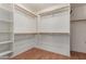 Spacious walk-in closet features custom shelving and rods, offering ample storage solutions at 2122 W Alta Vista Rd, Phoenix, AZ 85041