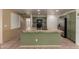 This spacious kitchen features an island with bar seating, stainless steel appliances, and green cabinets at 2122 W Alta Vista Rd, Phoenix, AZ 85041