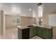 Open-concept kitchen with olive green cabinetry and a large island with sink and dishwasher offers plenty of counter space at 2122 W Alta Vista Rd, Phoenix, AZ 85041