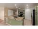 This kitchen has ample storage and features an island with bar seating and stainless steel appliances at 2122 W Alta Vista Rd, Phoenix, AZ 85041