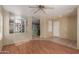 A view of the living room which showcases an open layout with wood-look floors and neutral colored walls at 2122 W Alta Vista Rd, Phoenix, AZ 85041