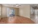 Cozy living area featuring wood-look flooring and sliding glass doors leading to the backyard and pool at 2122 W Alta Vista Rd, Phoenix, AZ 85041