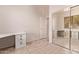 A well-lit bedroom features a built-in desk and mirrored closet doors at 21373 N 94Th Ave, Peoria, AZ 85382