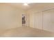 Neutral bedroom features a ceiling fan and sliding door closet with adjacent doorway at 21373 N 94Th Ave, Peoria, AZ 85382