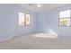 Bright bedroom features two windows, carpeted floors, and light blue walls at 21373 N 94Th Ave, Peoria, AZ 85382