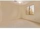 Bright bedroom features carpeted floors, a ceiling fan, and a large window for natural light at 21373 N 94Th Ave, Peoria, AZ 85382