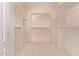 Bright, empty walk-in closet featuring double rods and carpeted floors provides ample storage at 21373 N 94Th Ave, Peoria, AZ 85382