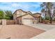 Spacious two-story home featuring a three-car garage and desert landscaping at 21373 N 94Th Ave, Peoria, AZ 85382