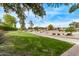 Community greenbelt with walking path, seating, and landscaped areas at 21373 N 94Th Ave, Peoria, AZ 85382