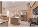 Spacious kitchen with stainless steel appliances and a center island at 21373 N 94Th Ave, Peoria, AZ 85382