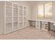 Bright home office offers a built-in desk and cabinets to showcase books or display collectibles at 21373 N 94Th Ave, Peoria, AZ 85382
