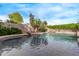 Relaxing backyard pool featuring rock accents and lush landscaping at 21373 N 94Th Ave, Peoria, AZ 85382