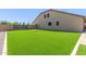 Expansive artificial turf backyard featuring a putting green, offering low-maintenance outdoor enjoyment at 21918 E Maya Rd, Queen Creek, AZ 85142