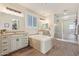 Spacious bathroom features a large soaking tub, dual vanity sinks, and a glass enclosed shower at 21918 E Maya Rd, Queen Creek, AZ 85142