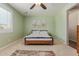 Bright bedroom boasts a light green paint, ceiling fan, and modern bed frame at 21918 E Maya Rd, Queen Creek, AZ 85142