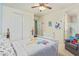 Sesame street themed bedroom includes a ceiling fan, natural carpet, and closet at 21918 E Maya Rd, Queen Creek, AZ 85142