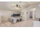Bonus room featuring a large desk setup, ceiling fan and neutral carpet at 21918 E Maya Rd, Queen Creek, AZ 85142