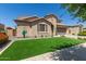 Beautiful home featuring a lush green lawn and low-maintenance desert landscaping at 21918 E Maya Rd, Queen Creek, AZ 85142